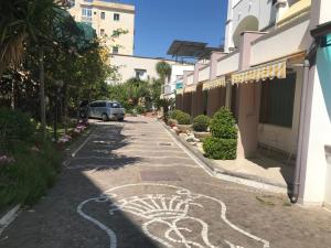 a street with a drawing on the side of a building at Maria Maddalena Holiday House in Vico Equense +12 photos