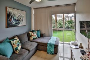 a living room with a couch and a window at 207 La Ballito-Luxury Family apartment in Ballito