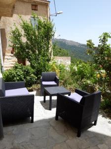 un gruppo di sedie e tavoli su un patio di Casa Franceschi a Pioggiola