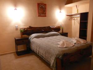 En eller flere senge i et værelse på Cabañas Mandala