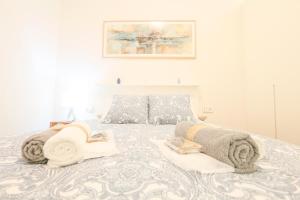 ein Schlafzimmer mit einem Bett mit Handtüchern darauf in der Unterkunft T&L TRIANA LOFT - Just like at home in Sevilla