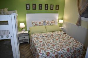 a small bedroom with a bed and two lamps at VILLA GARDEN in Tarragona