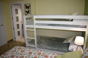 a bedroom with two bunk beds and a bed at VILLA GARDEN in Tarragona