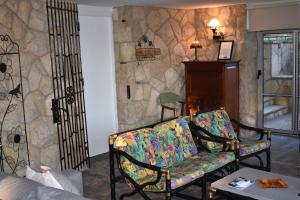 a living room with a couch and a stone wall at VILLA GARDEN in Tarragona