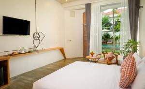 Un pat sau paturi într-o cameră la Phka Chan Hotel