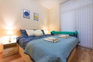 Säng eller sängar i ett rum på Domus Apartments Grand