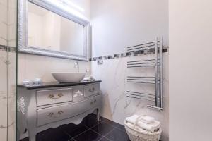 a white bathroom with a sink and a mirror at Arch III at Wenceslas in Prague
