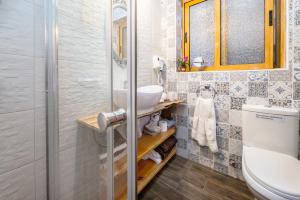 a bathroom with a sink and a toilet and a shower at Kharmen A 1565s House with Seaviews in Birgu