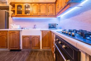 a kitchen with wooden cabinets and a counter top at Kharmen A 1565s House with Seaviews in Birgu