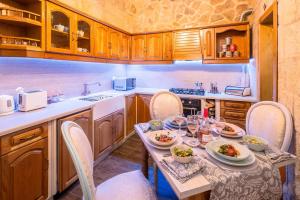a kitchen with a table with plates of food on it at Kharmen A 1565s House with Seaviews in Birgu
