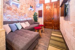 a living room with a couch and a door at Kharmen A 1565s House with Seaviews in Birgu