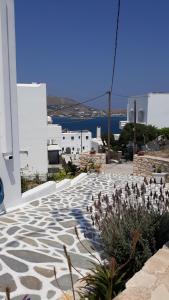 einen Steinweg mit Blick auf das Wasser und die Gebäude in der Unterkunft Athina's blue studios in Naoussa