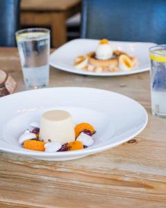 a plate of food on a table with two plates of food at The Randolph Hotel in Southwold