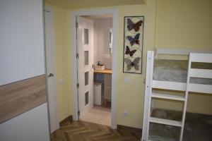 a small room with a bunk bed and a desk at VILLA GARDEN in Tarragona