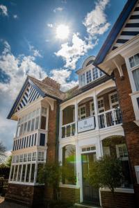 a brick building with the sun in the sky at The Randolph Hotel in Southwold