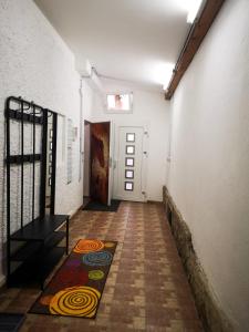 a hallway with a door and a rug on the floor at Millenium Inn Ferienwohnung Top 2 in Mürzzuschlag