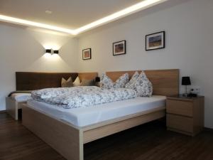 a bedroom with a large bed with pillows at APART BRADL in Hippach