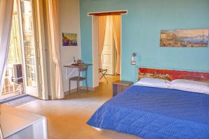 a blue bedroom with a bed and a table at Casa Amato in Naples