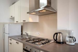 a kitchen with a stove top and a refrigerator at Sunrise Apartments Bol in Bol +33 photos