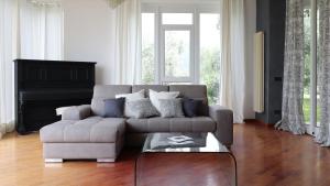 a living room with a couch and a piano at Italianway - San Bartolomeo 7 in Rapallo
