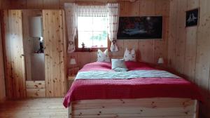 a bedroom with a large bed with a red blanket at Ferienhaus Barbara in Ebenthal