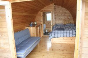 a bedroom with a bed in a log cabin at Glamping at Spire View Meadow in Lincoln