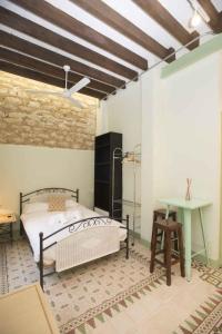 a bedroom with a bed and a desk in it at Vintage & Cosy Auditorium in Alicante +16 photos