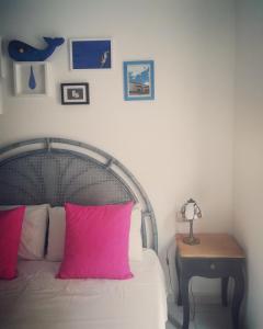 a bedroom with a bed, a lamp and a painting on the wall at Carilla B&B in Carloforte