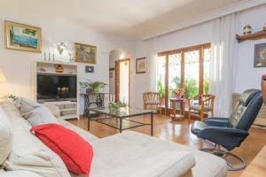 a living room with a white couch and a tv at El Pradillo in Palmanyola