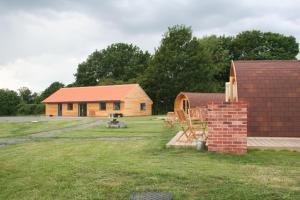 a house with a brick chimney in a yard at Glamping at Spire View Meadow in Lincoln