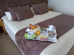 
a bed that has some food on it at Hotel Boa - Vista in Porto
