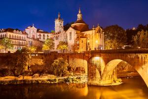 a bridge over a river in front of a city at Twin House - Amarante in Amarante