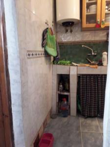 a small kitchen with a sink and a counter at dar stefano in Essaouira