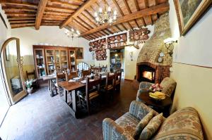 a living room with a dining table and a fireplace at Agriturismo Corboli in Vernio