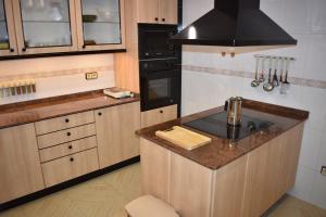 a kitchen with a counter with a sink and a stove at VILLA GARDEN in Tarragona