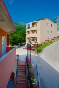 a set of stairs leading to a building with flowers at Alessandra Apartments in Sveti Stefan