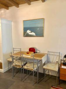 a table and chairs with a picture on the wall at Nefeli in Livadi