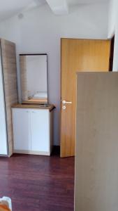 an empty room with a door and a mirror at Apartments Mirjana in Petrcane