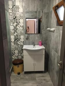 a bathroom with a sink and a mirror at Vila Angi in Mangalia +32 photos