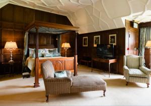 a bedroom with a bed and a couch and a chair at Hever Castle Luxury Bed and Breakfast in Edenbridge