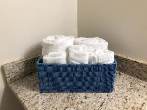 una canasta azul de toallas sentadas en un mostrador en Atlantic Breeze Suites, en Hampton