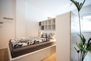 a bedroom with a bed and a mirror at City-Apartment Neubaugasse - PRIVATE PARKING GARAGE in Graz