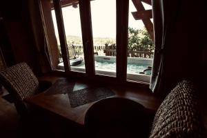 a room with a window with a view of a swimming pool at Aura Cabana - Cabane spa perchée à 6 m de haut in Saint-André-dʼOlérargues