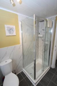 a shower stall in a bathroom with a toilet at Arrandale in Inverness