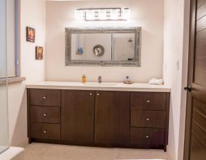 a bathroom with a sink and a mirror at Casa Del Gallo in Loreto +10 photos