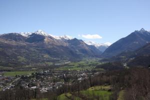 a town in a valley with snow capped mountains at Dolwin in Argelès-Gazost