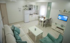 a living room with a couch and a table at Gloria Apartments 2 in Međugorje