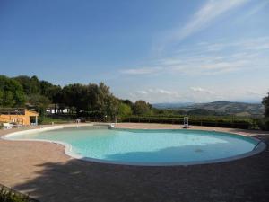 a large swimming pool in the middle of a patio at Camping Paradiso in Pesaro