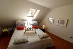 a bedroom with a bed with a table on it at LA MANSARDINA VINTAGE in San Benedetto del Tronto
