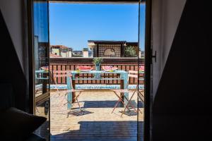 a view of a table and chairs from a window at LA MANSARDINA VINTAGE in San Benedetto del Tronto